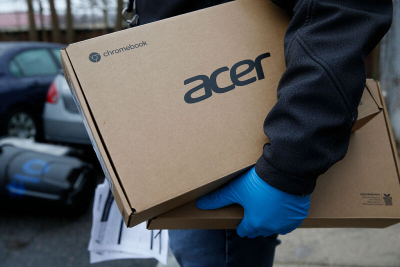 Man holdering two Acer laptop boxes
