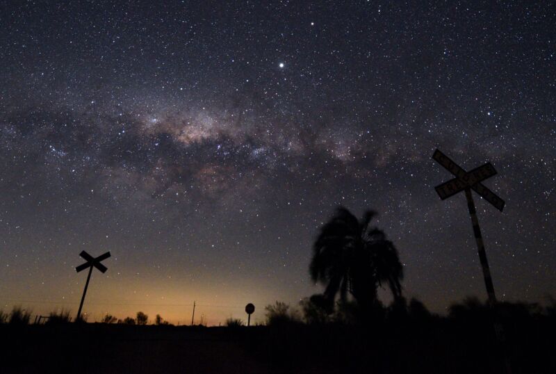 Milky Way's Galactic Center and Jupiter (brightest spot at center top) are seen from the countryside